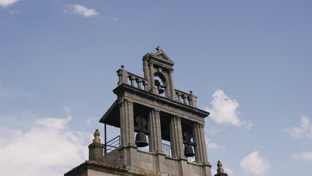 View of the bell tower of a Catholic church in a Spanish city. Close-up.