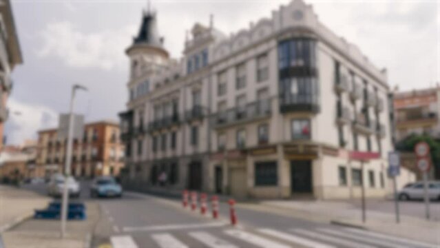 Astorga street along which cars drive, pedestrians walk. In the background is a building with a restaurant. Background, blurry video.