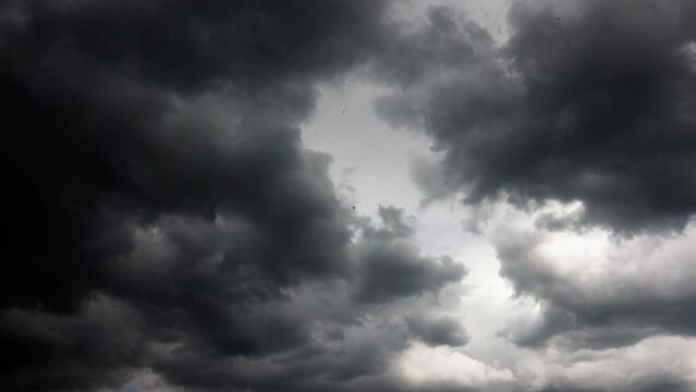 Clouds float across the blue sky and turn into thunderclouds. Summer sky before the rain, during the rain. time interval. 4k