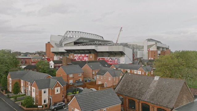 The Anfield Arch: A sweeping arch shot revealing the stadium and adjacent areas, wrapped in a cloudy ambiance.
