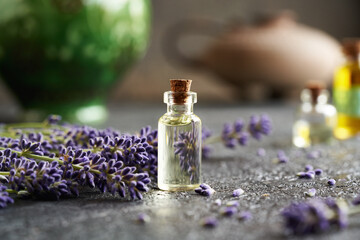 A transparent bottle of essential oil with lavender flowers