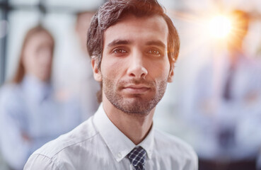 Confident man posing in front of his colleague during a meeting