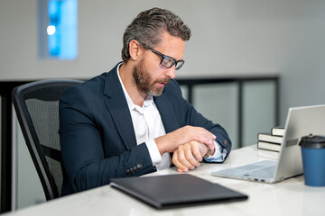 Fototapeta premium Office worker with laptop at office. Ofice employee remote working in modern office. Businessman on remote meeting, working online in offices place. Business man using computer in office.