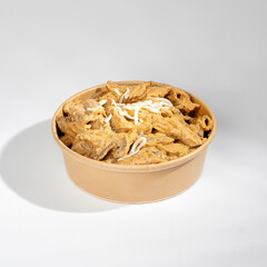 Pasta with mushrooms and red sauce on a white background