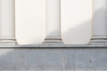 Architectural columns on white wall detail. Shade from the building in front at the church. - 650364997