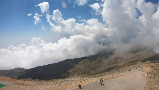 Climbing to the top by cable car in Olympos and watching the movements of the clouds in time-lapse with the camera.