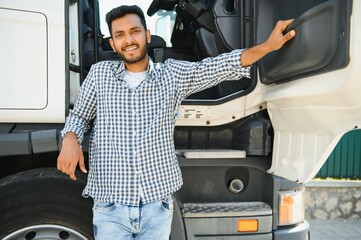 Young indian man standing by his truck. The concept of freight transportation.