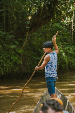 Ethnic man sailing on traditional boat