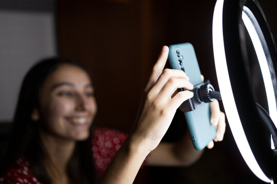 Female influencer setting equipment for shooting
