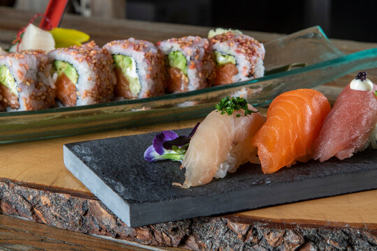 Sets of exquisite sushi on wooden board