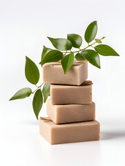 Organic handmade soap bars with green leaves on white background