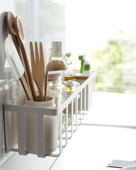 Wooden cutlery on the shelf in kitchen interior, vertical photo