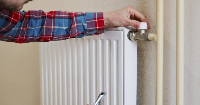 Monitoring and checking the heating systems of the apartment before the heating season, the plumber checks the connections and tap of the heat battery