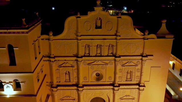 Aerial panning at night over the facade of the Cathedral of Comayagua in Honduras 