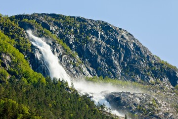 Majestic waterfall cascading down the rocky side of a mountainside