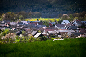 Spring countryside with beautiful spring light. Houses in the valley and the hills above them