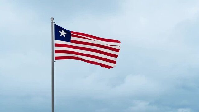 Liberia flag waving in the wind, cloudy blue sky with running clouds, endless seamless loop