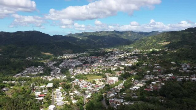 Drone footage over the mountain town and municipality of Comerio on a sunny day in Puerto Rico