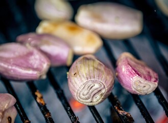 several onions sitting on a grill, which is being cooked