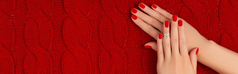 Fototapeten Womans hands with matt manicure on red knitted coverlet. Winter manicure, pedicure design trends © Darya Lavinskaya