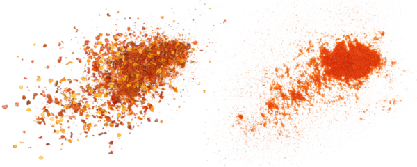 Crushed red cayenne pepper, dried chili flakes and ground minced paprika pile isolated on white, top view