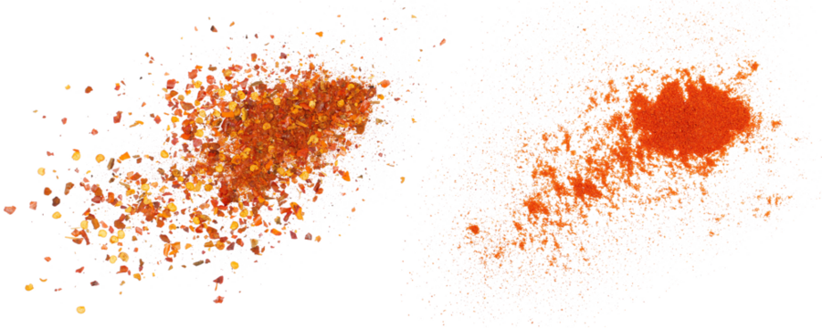 Crushed red cayenne pepper, dried chili flakes and ground minced paprika pile isolated on white, top view