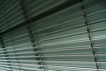 Workshop and office metal horizontal blinds line detail on background.