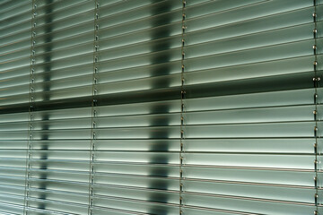 Workshop and office metal horizontal blinds line detail on background.