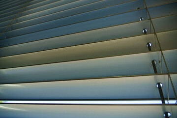 Workshop and office metal horizontal blinds line detail on background.