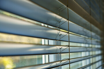 Workshop and office metal horizontal blinds line detail on background.