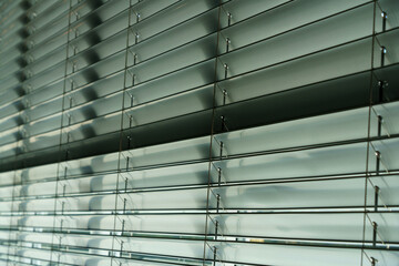 Workshop and office metal horizontal blinds line detail on background.