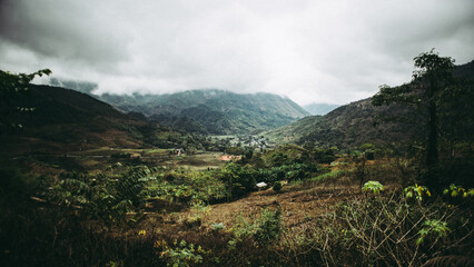 Fototapeta premium Beautiful view of a green landscape with mountains under the cloudy sky