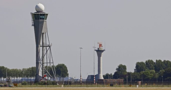 Amsterdam Schiphol airport - Polderbaan control tower and radar system on a hot summer day.