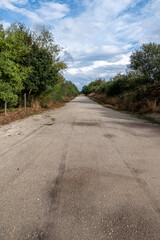 Fototapeta na wymiar Long and straight dirt track in a rural area