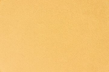 Vibrant yellow decorative plaster adorns the wall, adding a touch of warmth and style to any space