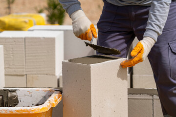 The bricklayer is working. Building a wall of aerated concrete. Gasbeton wall