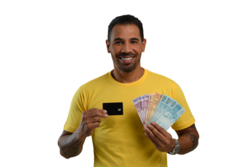 man holds a black credit card and Brazilian money, wearing a yellow shirt 