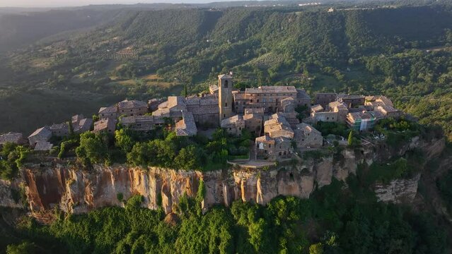 Civita di Bagnoregio, aerial view at sunrise, located on top of a volcanic tuff hill overlooking the Tiber river valley, province of Viterbo, Lazio, Italy