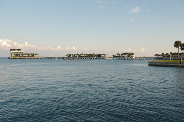Fototapeta premium Looking south east from Vinoy Park in St. Petersburg, Florida late afternoon sun toward pier and Tampa Bay. Wide angle view.