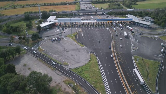 Aerial view of an Italian highway toll booth. Time-lapse cars queuing up to pay the highway toll and automatic paying lanes.