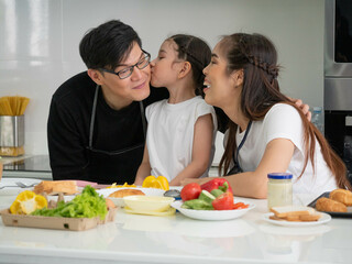 family father mother daddy mom female male woman man son girl group together love parent smile hug enjoy daughter happy smile pretty beautiful person people living room relationship embrace kitchen   