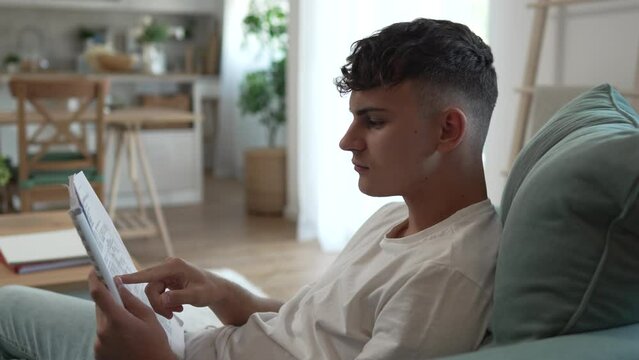 Young caucasian man teenager student study at home