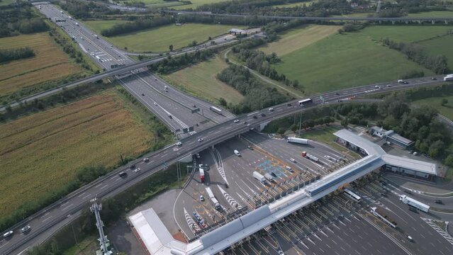 Aerial view of an Italian highway toll booth. Time-lapse cars queuing up to pay the highway toll and automatic paying lanes.