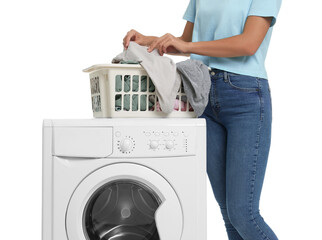Woman taking laundry out of basket and washing machine on white background, closeup
