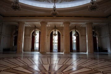 Selective blur on giant windows and opulent design of a hall in the interior of the Romanian palace...