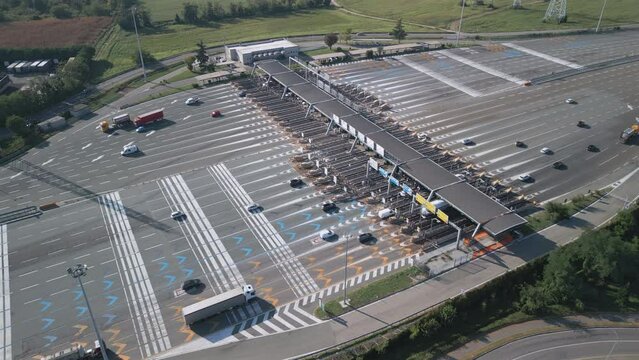 Aerial view of an Italian highway toll booth. Time-lapse cars queuing up to pay the highway toll and automatic paying lanes.