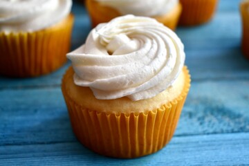 Vanilla cupcake on blue background