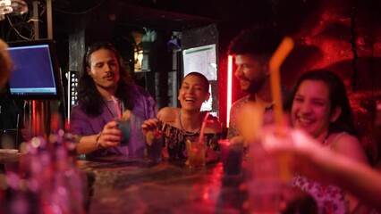 Young and diverse group of friends having a toast while drinking cocktails on their night out in a bar - Powered by Adobe