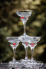 Tower of champagne glasses on a table outdoors. High quality photo