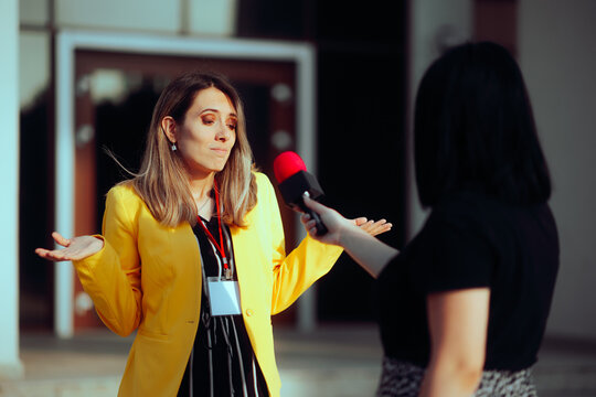 Woman Not Knowing What to Answer in a Street Interview. Reporter asking uncomfortable questions to a public relation specialist 
